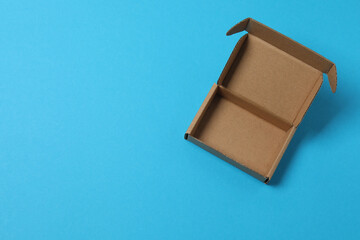 empty paper box with lid on blue background, top view
