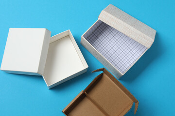 empty paper box with lid on blue background, top view
