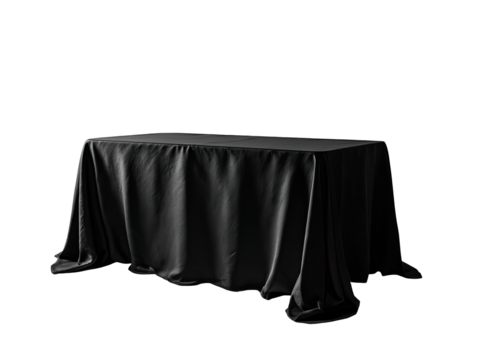 A draped, dark gray table against a black backdrop