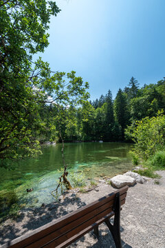 Badersee lake in Bavaria, Germany, with clear water and lush green forest in summer