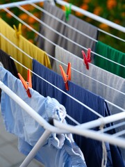Washed laundry hanging on a clothing dryer rack outdoors