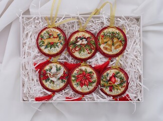 Cardboard box with set of six cross stitched Christmas Old World Holiday Ornaments. This round Christmas ornaments embroidered and made by myself.