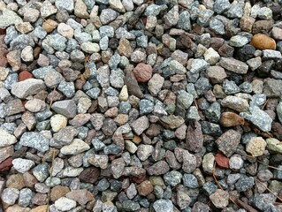 Colorful small gravel stones creating natural textured background surface pattern.