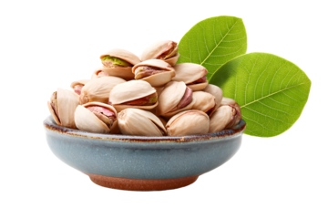Bowl of pistachio nuts with green leaves isolated on transparent background, healthy snack food for natural nutrition and culinary ingredient

