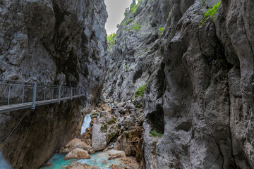 Dramatic alpine gorge with narrow passage and towering rock walls in the Bavarian Alps