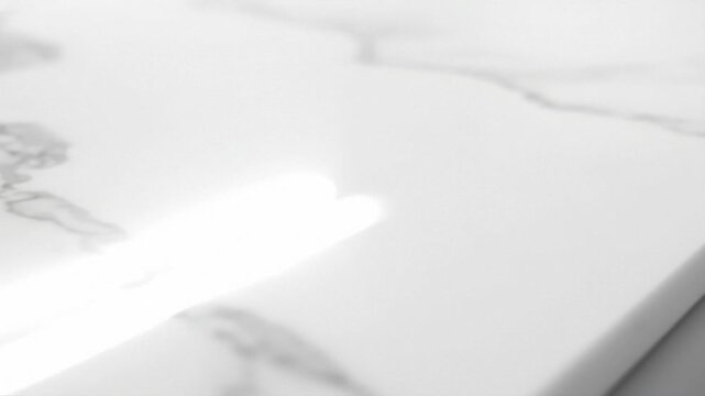 Elegant white marble surface reflecting bright light, luxurious natural stone