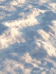Close-up view of snow-covered landscape showing textured ice formations and soft shadows on pristine winter surface under natural sunlight