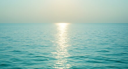 Obraz premium Tranquil turquoise ocean under soft sunlight horizon creating a serene seascape