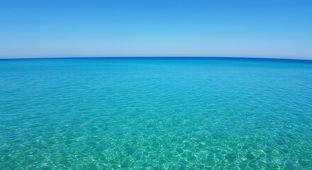 Tranquil turquoise ocean waters under a bright blue sky horizon