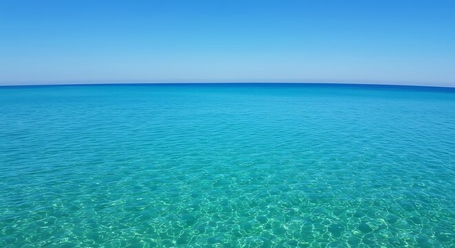Tranquil turquoise ocean waters under a bright blue sky horizon - Powered by Adobe