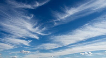 Vibrant blue sky with wispy white clouds evoking peace and tranquility
