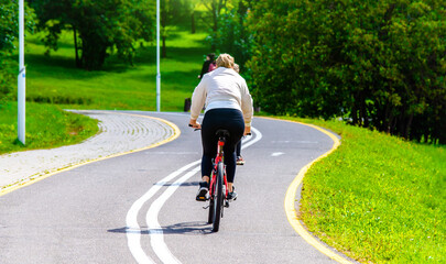 Fototapeta premium Cyclist ride on the bike path in the city Park 