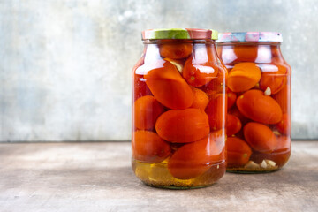 Pickled tomatoes in jars.