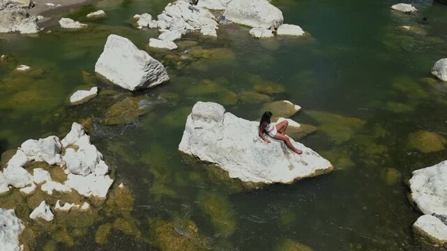 Lying on a rock at Tinipak River, Tanay, Rizal, a woman moves gently as the drone hovers above&mdash;capturing a flowing, cinematic moment blending human grace with nature&rsquo;s rugged beauty.