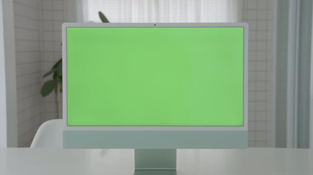 Laptop Computer with Green Screen on a Home Work Desk, High-Quality 4K HD Footage