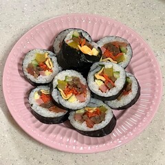 Delicious kimbap rolls filled with fresh vegetables, seasoned rice, and savory proteins, all wrapped in crisp seaweed. A perfect combination of flavor and texture in every bite.
