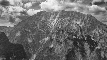 Dramatic black and white view of the Watzmann massif with rugged alpine rock faces and clouds