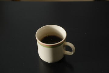 A cup of freshly brewed strong and black homemade coffee for a good mood