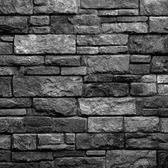 Fototapeta premium Close-up view of a stone wall, composed of irregular, rectangular blocks in shades of gray