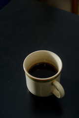 A cup of freshly brewed strong and black homemade coffee for a good mood