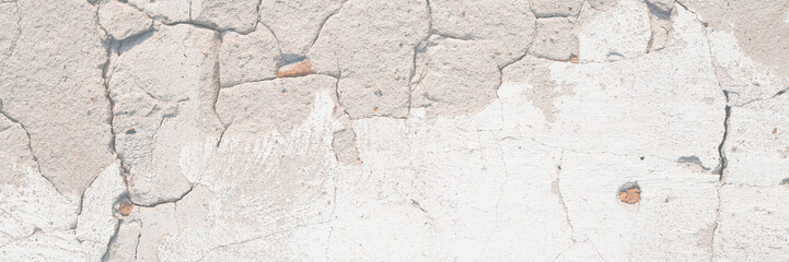 Concrete wall texture with cracked plaster. Weathered uneven rough surface. Perfect for background and grunge design.