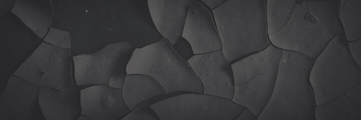 Dark wide panoramic background. Peeling paint on a concrete wall. Faded dark texture of old cracked...