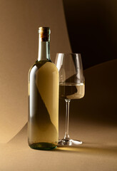 Bottle and glass of white wine.
