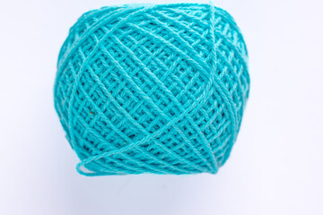 Light blue knitting yarn - a spool with intertwined threads on a white background
