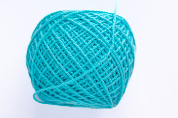 Bright blue Chunky yarn in a ball of thread with texture on a white background