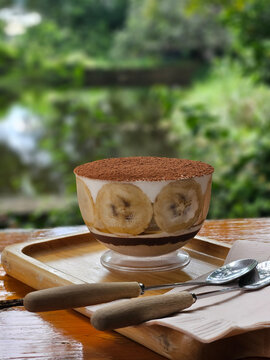 Homemade banoffee banana cream cake serving in clear cup