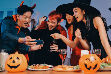 Fototapeta premium Friends enjoying a Halloween party at a bar making a toast