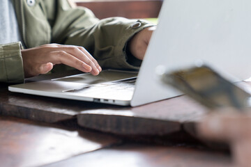 Female hands typing on laptop keyboard, close-up view, concept of work, study, online communication, and modern digital lifestyle.