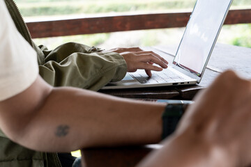 Female hands typing on laptop keyboard, close-up view, concept of work, study, online communication, and modern digital lifestyle.