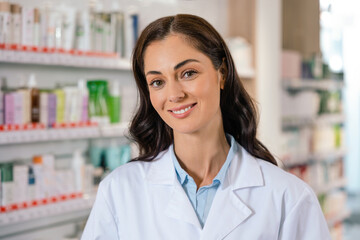 Professional woman doctor working in pharmacy smiling confidently