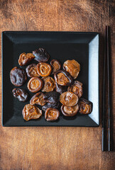 Japanese shiitake mushrooms marinated on rustic wooden background 