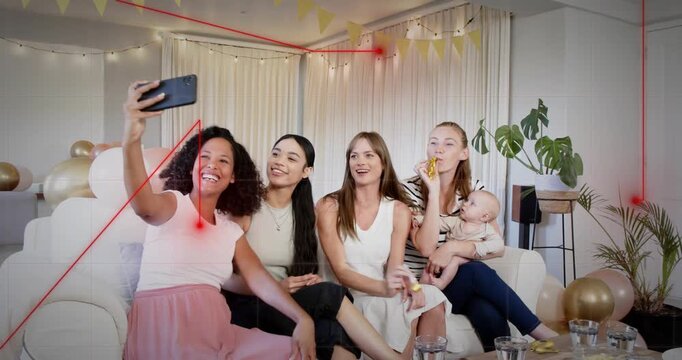Woman lifting smartphone initiating tech party selfie, group blowing horns, infant reaching pastry