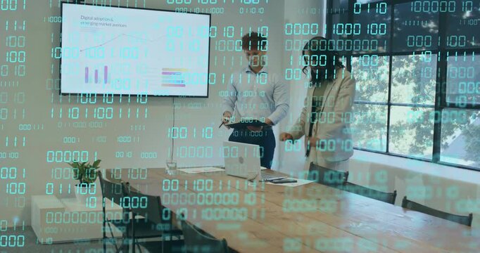 Man and woman leaning over laptop tapping figures while pointing at wall chart for market analysis