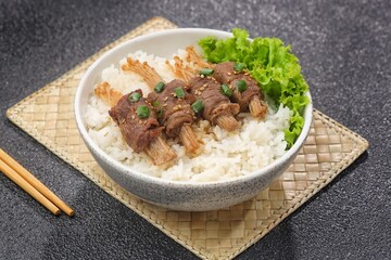 Beef enoki roll is a rolled sheet of beef filled with enoki mushrooms.