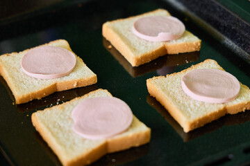 Delicious Sliced Bread with Ham Cooked on a Griddle for a Hearty Breakfast or Lunch