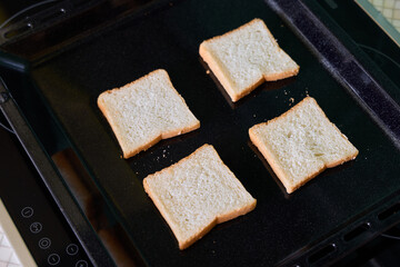 Golden Brown Toasted Bread Slices Cooked Perfectly on a Hot Griddle for Deliciousness