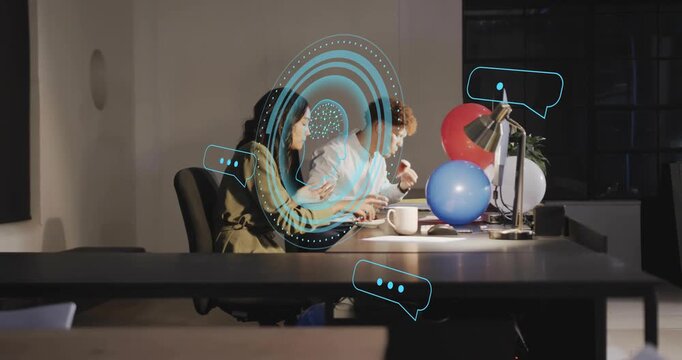 Two colleagues biting pastries and activating virtual rings plus bubbles marking business milestone