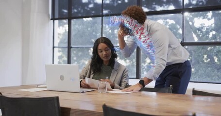 Man ending phone call guiding colleague through business papers with holographic globe overlay - Powered by Adobe