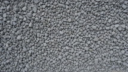 Close up view of a gray concrete texture with various embedded aggregate stones