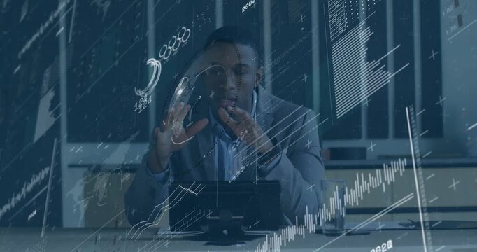 Businessman resting hands activating charts rotating globe and framing line graph for analysis - Powered by Adobe