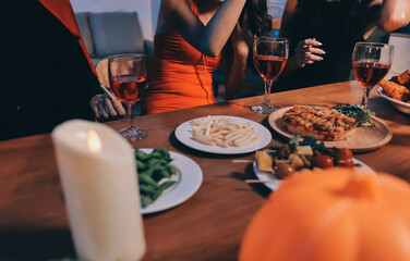 Friends enjoying a Halloween party at a bar making a toast