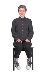 Full length portrait of a young woman sitting on a chair waiting as keeps hands on knees. Businesswoman job recruitment and employment concept. Seated female isolated on transparent background
