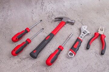 Essential Tools For Home Repair And DIY Projects Laid Out On Concrete Surface