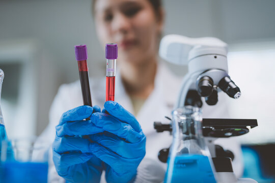 Scientist holding blood samples for laboratory analysis