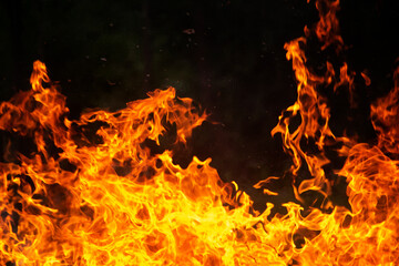 Close up burning flames on black background for graphic design or wallpaper.