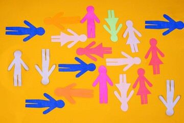 Colorful Paper Cutouts Of People Forming Isolated On Yellow Background